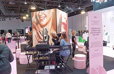 Visitors At The Pure Booth, Experiencing Makeup Demos At The Exhibition