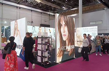 Visitors at the Marc Weiss Paris booth, exploring hair products at the exhibition